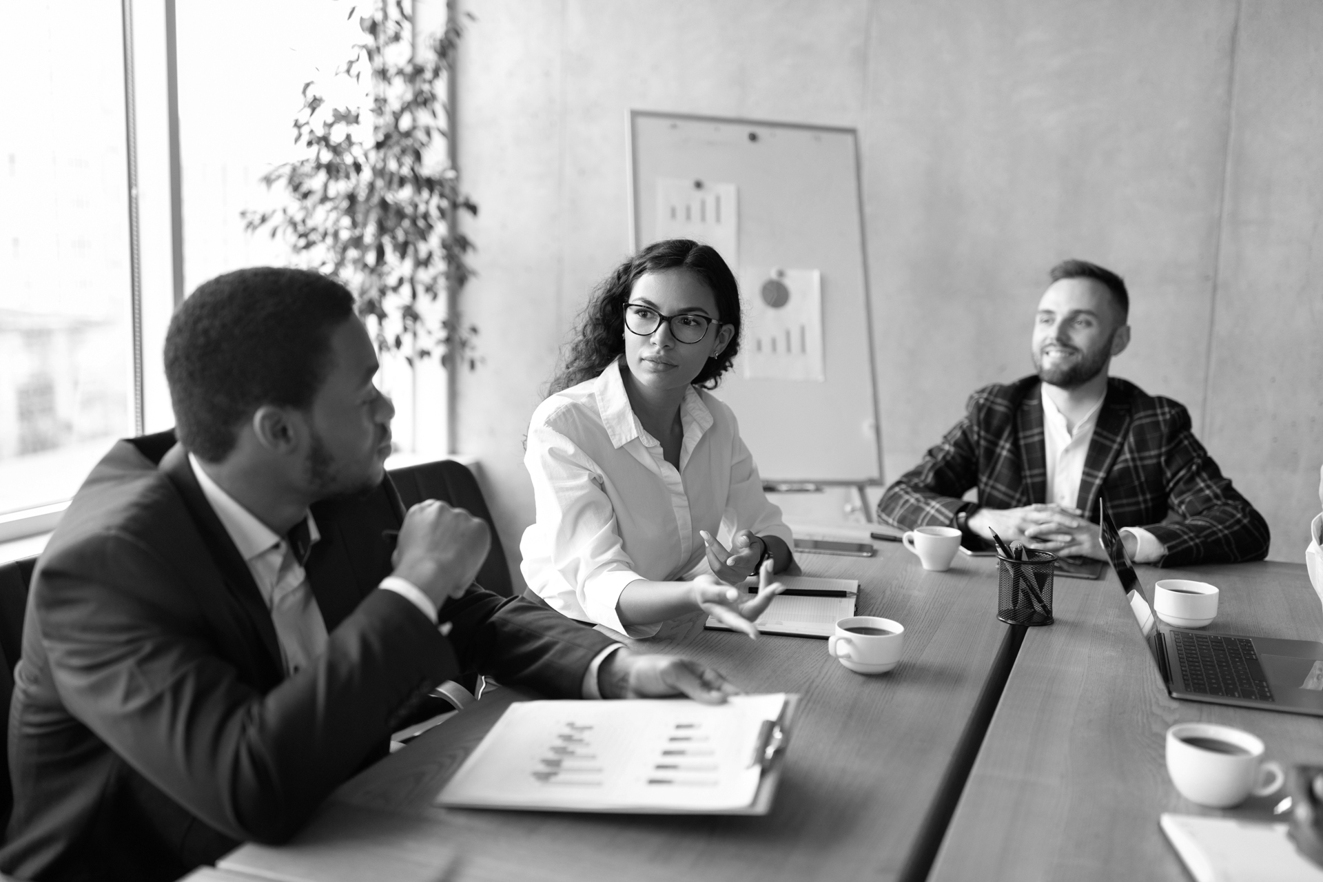 coworkers-at-corporate-meeting-discussing-work-sit-SHSKA74